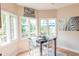 Cozy dining area with a dark table and chairs bathed in natural light from large windows at 2901 Hazel Foster Dr, Carmel, IN 46033