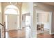 Elegant foyer featuring hardwood floors and arched entry, with a glimpse into the dining room at 2901 Hazel Foster Dr, Carmel, IN 46033
