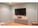 Modern living room with light blue walls, floating entertainment center, and laminate flooring at 2901 Hazel Foster Dr, Carmel, IN 46033