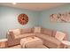 Stylish living room with a plush sectional sofa, decorative pillows, and unique clock wall decor at 2901 Hazel Foster Dr, Carmel, IN 46033