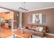 Cozy living room featuring a leather couch, wood coffee table, and access to the kitchen at 2901 Hazel Foster Dr, Carmel, IN 46033