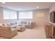 Bright living room featuring a comfortable sectional sofa, ottoman, and large windows for natural light at 2901 Hazel Foster Dr, Carmel, IN 46033