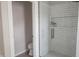 Modern glass-enclosed shower with white subway tile and built-in shelving for storage at 2901 Hazel Foster Dr, Carmel, IN 46033