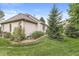 Exterior view of a brick home featuring a well-manicured lawn and mature trees at 2920 Bloomsbury S, Greenwood, IN 46143