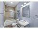Charming bathroom featuring a pedestal sink, tub/shower combination, and decorative lighting at 2920 Bloomsbury S, Greenwood, IN 46143