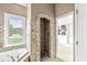 Bathroom featuring decorative tile shower, soaking tub, and plenty of natural light at 2920 Bloomsbury S, Greenwood, IN 46143
