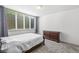 Bedroom featuring a large window with blinds, a full-size bed, and a wooden dresser at 2920 Bloomsbury S, Greenwood, IN 46143