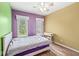 Bedroom with two windows providing ample light, hardwood floors, and a ceiling fan at 2920 Bloomsbury S, Greenwood, IN 46143