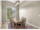 Formal dining room with a large wooden table, comfortable seating, and a window view at 2920 Bloomsbury S, Greenwood, IN 46143