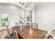 Inviting dining area with hardwood floors, a rustic table, and natural light from arched windows at 2920 Bloomsbury S, Greenwood, IN 46143