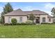 Charming single-story home with a brick facade, arched entryway, and well-manicured front lawn at 2920 Bloomsbury S, Greenwood, IN 46143