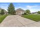 Side view of a detached garage with a long concrete driveway and manicured landscaping at 2920 Bloomsbury S, Greenwood, IN 46143