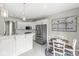Bright kitchen with stainless steel appliances, white cabinets, and a cozy breakfast nook with Gathering themed decor at 2920 Bloomsbury S, Greenwood, IN 46143