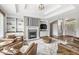 Elegant living room with a cozy fireplace, built-in shelving, and comfortable seating arrangement at 2920 Bloomsbury S, Greenwood, IN 46143