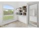 Bright walk-in closet featuring built-in shelving and a window overlooking the landscaped yard at 2920 Bloomsbury S, Greenwood, IN 46143