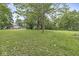 Sprawling backyard with a lush green lawn and mature trees offers a serene and spacious outdoor retreat at 3090 N County Road 800 E Rd, Brownsburg, IN 46112
