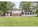 Well-maintained backyard featuring a stone patio with seating, and views of the home and surrounding landscape at 3090 N County Road 800 E Rd, Brownsburg, IN 46112