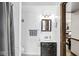Compact bathroom featuring dark vanity, decorative mirror, and shower with modern fixtures at 3090 N County Road 800 E Rd, Brownsburg, IN 46112
