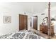Bright, open bedroom features a stylish four-poster bed, a dresser, and an interior hall at 3090 N County Road 800 E Rd, Brownsburg, IN 46112