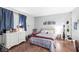 Bedroom with hardwood floors and blue curtains creates a calming and comfortable living space at 3090 N County Road 800 E Rd, Brownsburg, IN 46112
