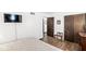 Cozy bedroom with dark wood flooring, entertainment center, a wardrobe, and an interior hall for ample storage at 3090 N County Road 800 E Rd, Brownsburg, IN 46112