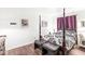 Bright bedroom features a stylish four-poster bed and a set of padded seating near the foot at 3090 N County Road 800 E Rd, Brownsburg, IN 46112