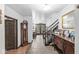Foyer with a vintage grandfather clock, a staircase, and a hallway with a decorative mirror at 3090 N County Road 800 E Rd, Brownsburg, IN 46112