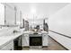 Open-concept kitchen with a stove island overlooking the dining area and staircase at 3090 N County Road 800 E Rd, Brownsburg, IN 46112