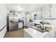 Bright kitchen with white cabinets, stainless steel appliances, and a view of the backyard at 3090 N County Road 800 E Rd, Brownsburg, IN 46112