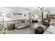 Spacious living room featuring tile flooring, a ceiling fan, and a view of the kitchen at 3090 N County Road 800 E Rd, Brownsburg, IN 46112