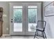 View of the double doors leading to the back porch with peaceful views and outdoor seating at 3641 Harrison St, Needham, IN 46162