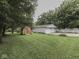 Large backyard features a shed and a detached garage with ample space for parking and storage at 3641 Harrison St, Needham, IN 46162