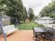Inviting backyard featuring a deck, swing set, and detached garage, perfect for outdoor gatherings at 3641 Harrison St, Needham, IN 46162