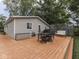Enjoy outdoor living on this spacious deck with a grill, seating, and a peaceful backyard view at 3641 Harrison St, Needham, IN 46162