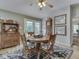 The dining room features a round table with chairs, a grandfather clock, and French doors to the backyard at 3641 Harrison St, Needham, IN 46162