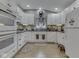 Well-lit kitchen features white cabinets, dark countertops and stainless steel appliances at 3641 Harrison St, Needham, IN 46162