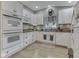 Bright kitchen features white cabinets, dark countertops, and stainless steel double oven at 3641 Harrison St, Needham, IN 46162