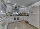 Well-lit kitchen with white cabinets, dark countertops, and modern appliances at 3641 Harrison St, Needham, IN 46162