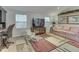 Bright living room with a patterned rug, a comfortable sofa, and natural light from two windows at 3641 Harrison St, Needham, IN 46162