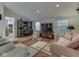 Bright living room with comfortable seating, a large TV, and a home office area with a desk at 3641 Harrison St, Needham, IN 46162