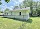 Fenced backyard with an expansive grassy area and a detached shed for extra storage at 3712 S Kealing S Ave, Indianapolis, IN 46237