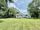 Spacious backyard with lush green grass and mature trees, perfect for outdoor activities and relaxation at 3712 S Kealing S Ave, Indianapolis, IN 46237