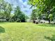 Large, lush backyard with multiple storage sheds and lots of shade trees for privacy at 3712 S Kealing S Ave, Indianapolis, IN 46237