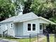 Charming home featuring light siding, a cozy front porch, and well-maintained landscaping at 3712 S Kealing S Ave, Indianapolis, IN 46237