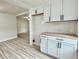 Bright kitchen features white cabinets, light countertops, and modern hardware and opens to the living area at 3712 S Kealing S Ave, Indianapolis, IN 46237