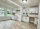 Renovated kitchen featuring bright, white cabinetry, butcher block countertops, and stylish fixtures at 3712 S Kealing S Ave, Indianapolis, IN 46237