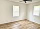 Bright bedroom with wood-look flooring and natural light from two windows at 405 E Cowing Dr, Muncie, IN 47303
