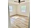 Bright bedroom with wood-look flooring, a ceiling fan, and natural light from the windows at 405 E Cowing Dr, Muncie, IN 47303