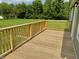 A wooden deck overlooking the property's spacious backyard at 405 E Cowing Dr, Muncie, IN 47303