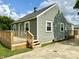 A charming exterior showcasing tidy siding, a front deck, and well-manicured landscaping at 405 E Cowing Dr, Muncie, IN 47303